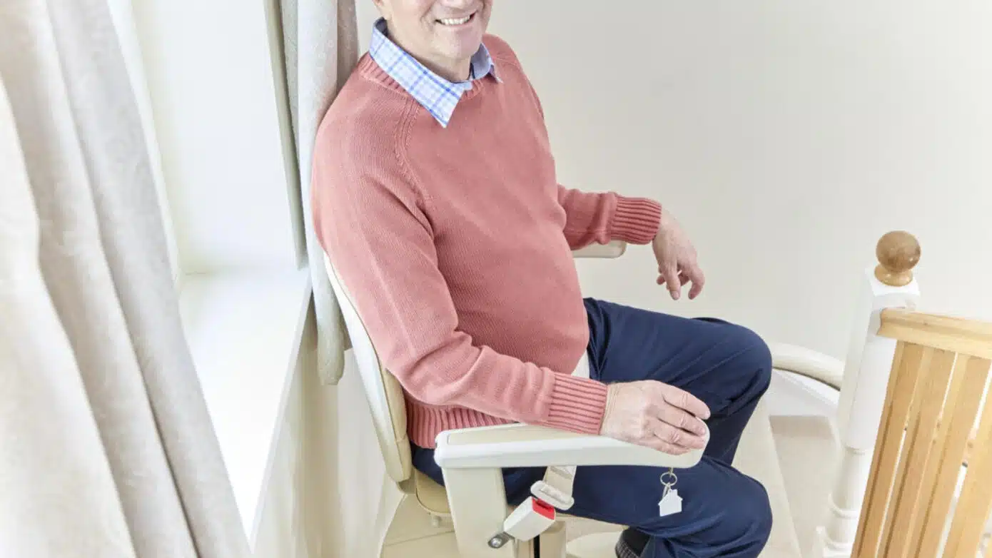 old man stitting on stairlift