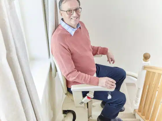 old man stitting on stairlift